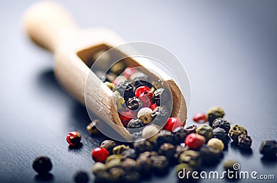 Colorful spices on a dark blue table. Concept of kitchen and cooking. Spicy on a wooden spoon. Stock Photo