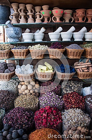 Colorful spices nuts dried flowers minerals and pestle for cooking at open air spice market Stock Photo