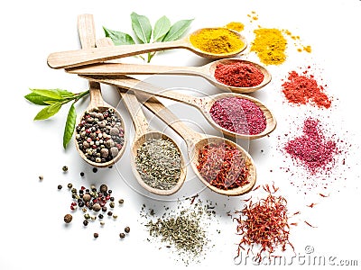 Colorful spices in the wooden spoons on the white Stock Photo