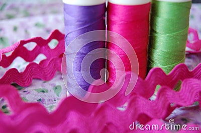 Extreme closeup of colorful spools of thread in purple, pink and green Stock Photo