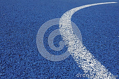 Colorful sports court background. Light blue field rubber ground with curved white line outdoors. Top view Stock Photo