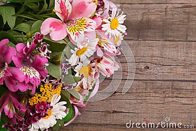 Colorful Spring bouquet of flowers on the wooden background. Stock Photo