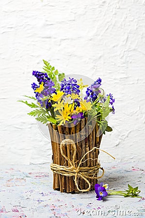 Colorful spring flowers in a rustic vase Stock Photo