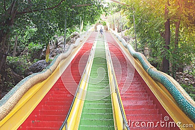 Colorful stairs going up to top floor of Thum Sua Temple or Tiger Cave Temple, Kanjanaburi Provine. Stock Photo