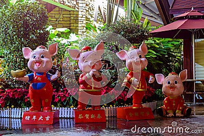 Colorful statues of four little pigs on the street of Sanya at cloudy day Editorial Stock Photo