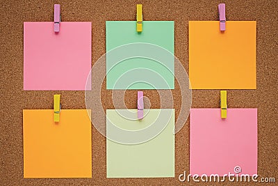 Colorful stickers on the clothespin on cork board, wood background. Concept of planning. Note for writing. Sticky notes, blank pap Stock Photo