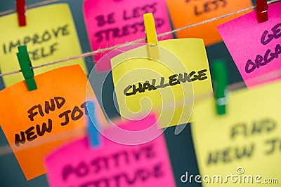 Colorful sticky notes with positive affirmation words and phrases hung from a clothesline by clothespins. Stock Photo