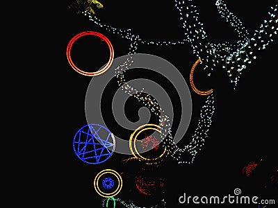 Colorful street christmas lights. Circles in red blue and gold and branches of trees Stock Photo