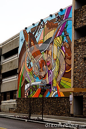 Colorful street painting of a male and a horse on the parking garage in Ogden City Utah Editorial Stock Photo