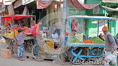 NAWALGARH, RAJASTHAN, INDIA - DECEMBER 28, 2017: Colorful street scene at the vegetable market with food stalls Editorial Stock Photo