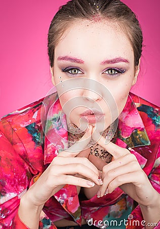 Colorful Studio portrait of a beautiful young woman in bright pink clothes Stock Photo