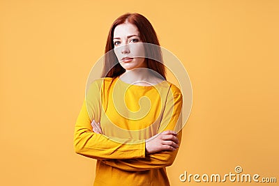 Colorful studio portrait of confident young woman with her arms folded Stock Photo