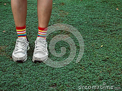 Colorful stylish socks on green field Stock Photo