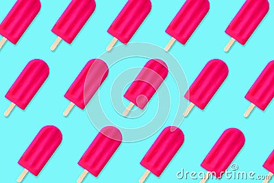Summer pattern of pink popsicles on a blue background Stock Photo