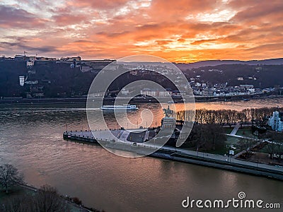 Colorful Sunrise burning sky Koblenz City historic monument German Corner where river rhine and mosele flow together Stock Photo
