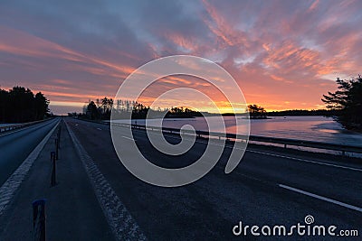 Colorful sunrise with clouds in the sky and frozen lake Stock Photo