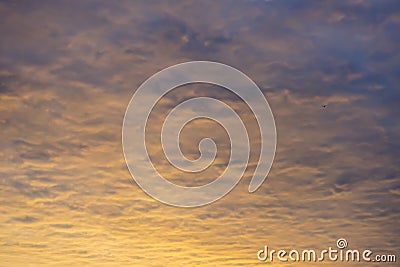 Colorful sunrise cloudscape background with vibrant yellows, ora Stock Photo