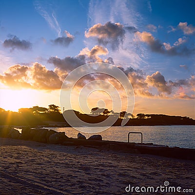 Colorful sunrise on the Tuscan coast in winter with the sun reflecting on the clouds and sea, shot with analogue film technique Stock Photo