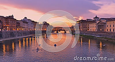 Colorful sunset with lights on Ponte Vecchio bridge in Florence, Italy Stock Photo