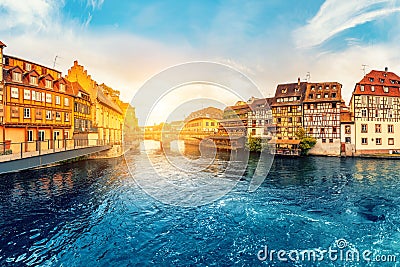 sunset in the region of Little France in the city of Strasbourg. Famous half-timbered houses, the river Ill and the Stock Photo