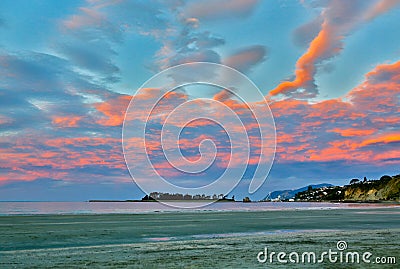 Colorful sunset sky with overcast clouds at Wharariki Beach, Nelson Stock Photo