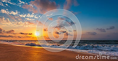 Colorful sunset with wave splashes on the beach Stock Photo