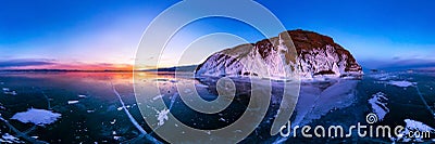 Colorful sunset on winter lake Baikal near an island covered with ice. . Cylindrical panorama 360 Stock Photo