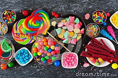 Colorful sweet candy buffet table scene, above view over dark stone Stock Photo