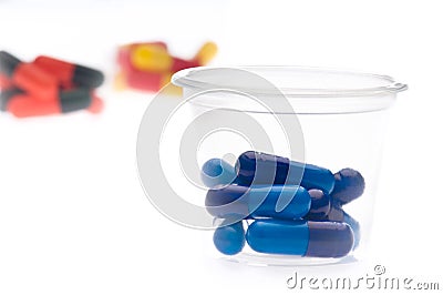 Colorful tablets, capsules in a cup Stock Photo