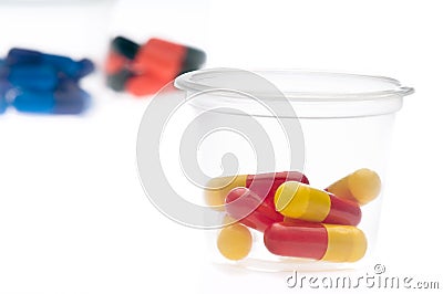 Colorful tablets, capsules in a cup Stock Photo