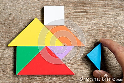 Colorful tangram puzzle in home shape wait for fulfill Stock Photo