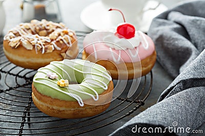 Colorful tasty donuts on a cooling rack Stock Photo