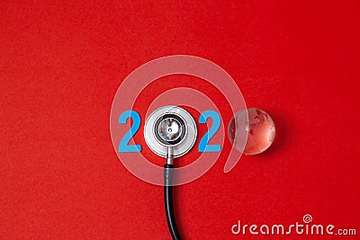 Colorful on text 2020 banner for health care and gobal medical concept. black stethoscope,on table red background Stock Photo