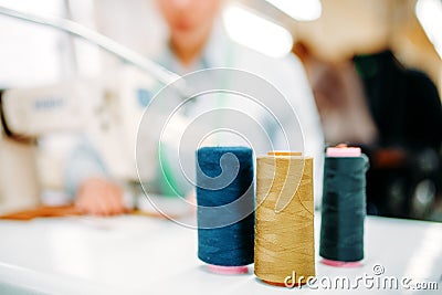 Colorful threads on spools closeup, dressmaking Stock Photo