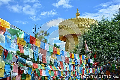 Colorful tibetian flags and biggest buddhist wheel in the world Stock Photo