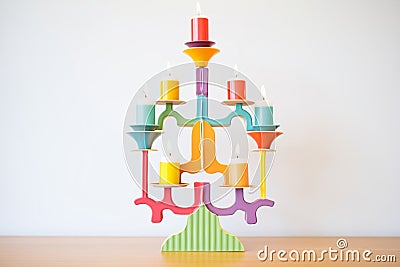colorful, tiered candlestick holder with multiple lit candles Stock Photo