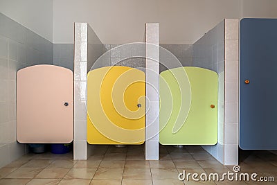 Colorful toilet doors in elementary school bathroom interior Stock Photo