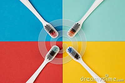 Colorful toothbrushes on four colored background Stock Photo