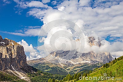 Colorful top view to Sassolungo mountain in the clouds on a Sunny summer day from Passo Sella di val Gardena Dolomites Stock Photo
