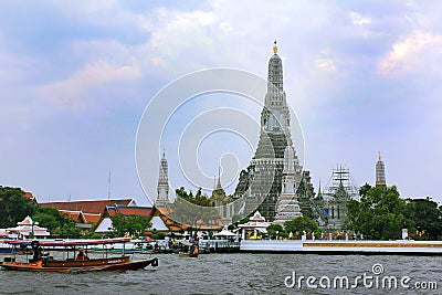 Colorful tourist boats and Wat Arun temple in Bangkok, Thailand Editorial Stock Photo