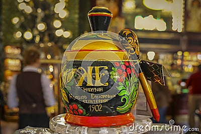 Colorful traditional Russian Hohloma or Khokhloma laquer jar and spoon at the Eliseevsky store, Saint Petersburg, Russia Stock Photo