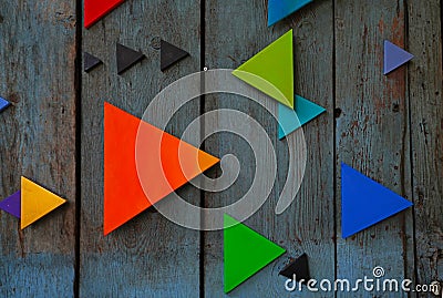 Colorful triangles on wooden surface Stock Photo