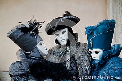 Colorful trio carnival black-blue mask and costume at the traditional festival in Venice, Italy Editorial Stock Photo