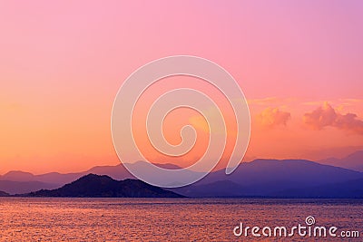 Colorful twilight seascape. Clouds and mountains on the horizon Stock Photo