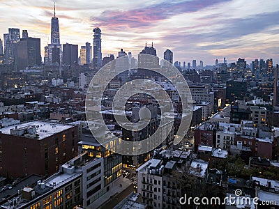 Colorful twilight of sunset shines in the sky above the buildings of the lower Manhattan skyline in New York City Stock Photo