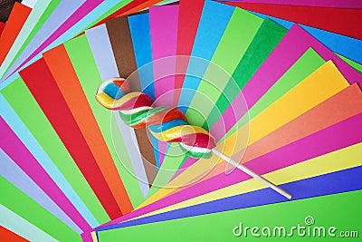 Colorful twisted sweet lollipop with brightly colored papers Stock Photo