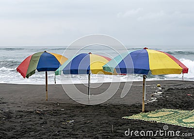 Colorful umbrellas on the sand in Parangtritis Beach, Yogyakarta, Indonesia Stock Photo