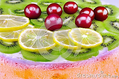 Colorful unbaked homemade fruit cake with cream and sweet cherries Stock Photo