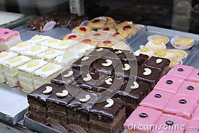 Colorful and variety cakes background on an open shop at Kolkata with selective focus. Stock Photo