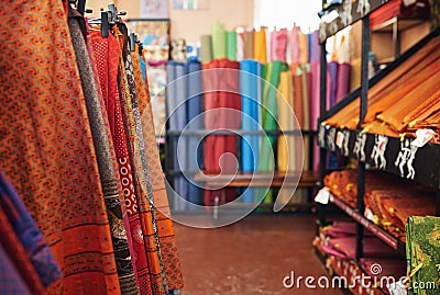 Colorful printed textiles on display in a fabric store Stock Photo